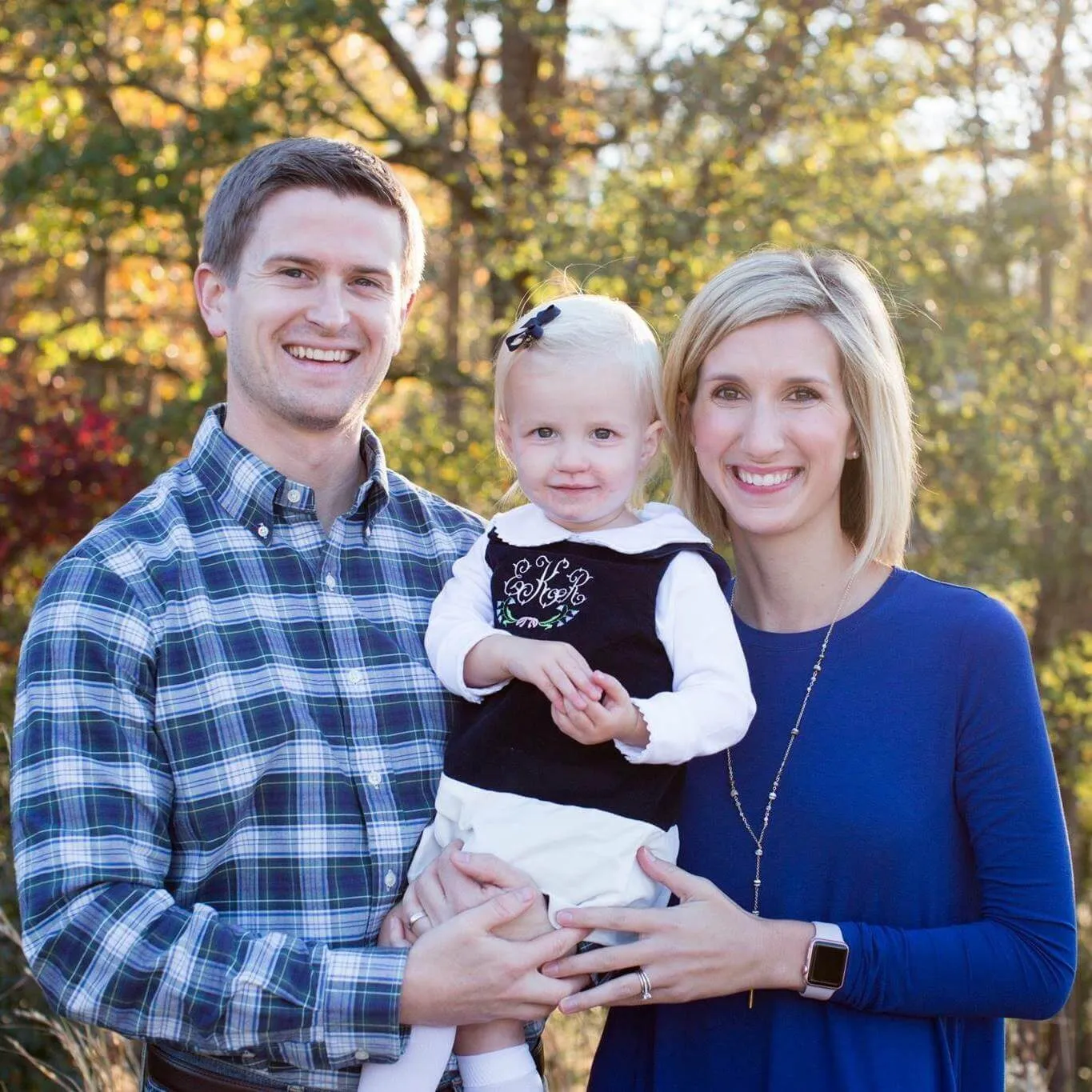 Emily with her family, holding her daughter Ellie